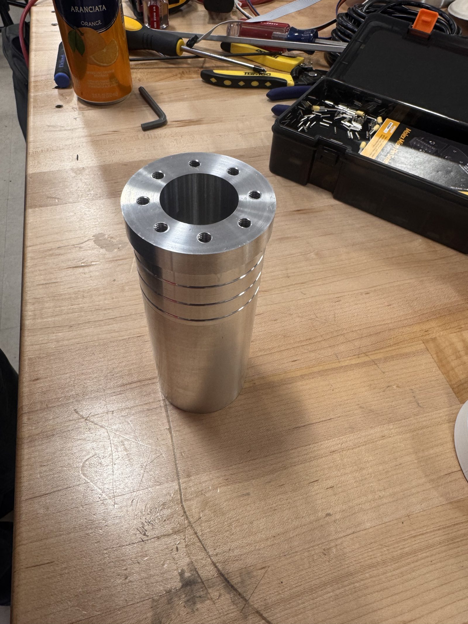 Machined aluminum tube plug with a bolt-hole flange