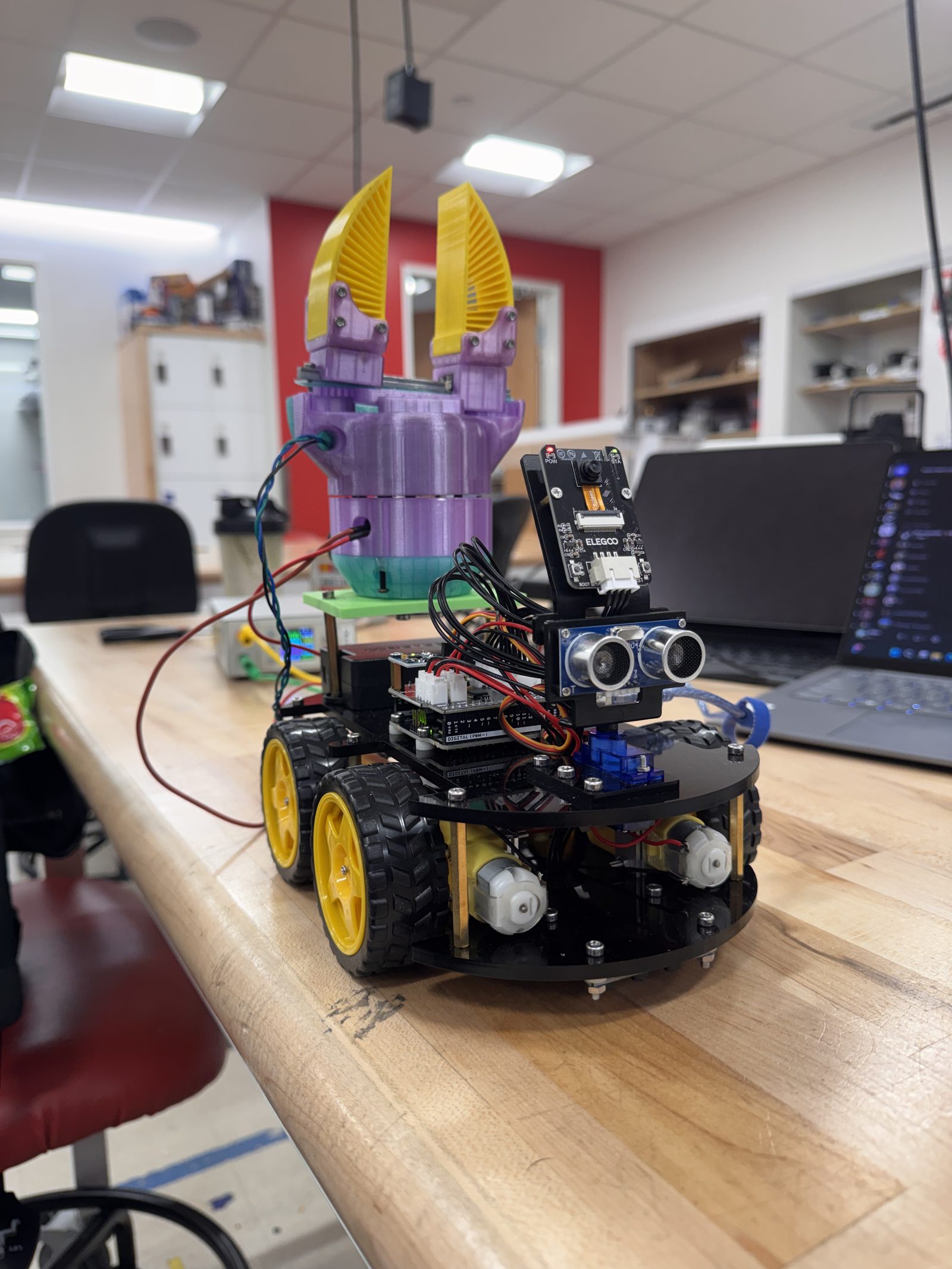 Assembled adaptive fin-ray gripper mounted on a robot chassis in the lab