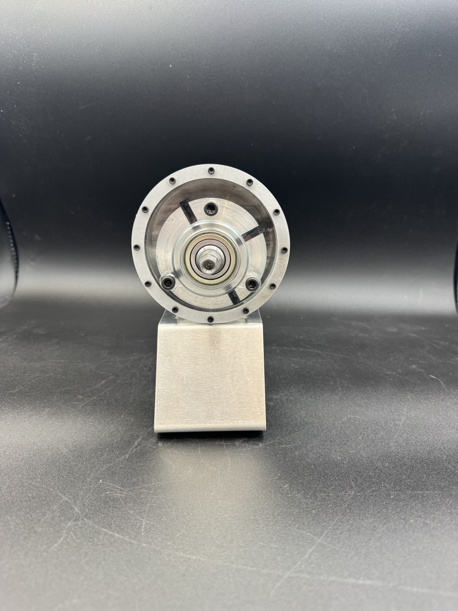 Front view of the machined rotary vane pump housing showing the rotor bore and bolt pattern