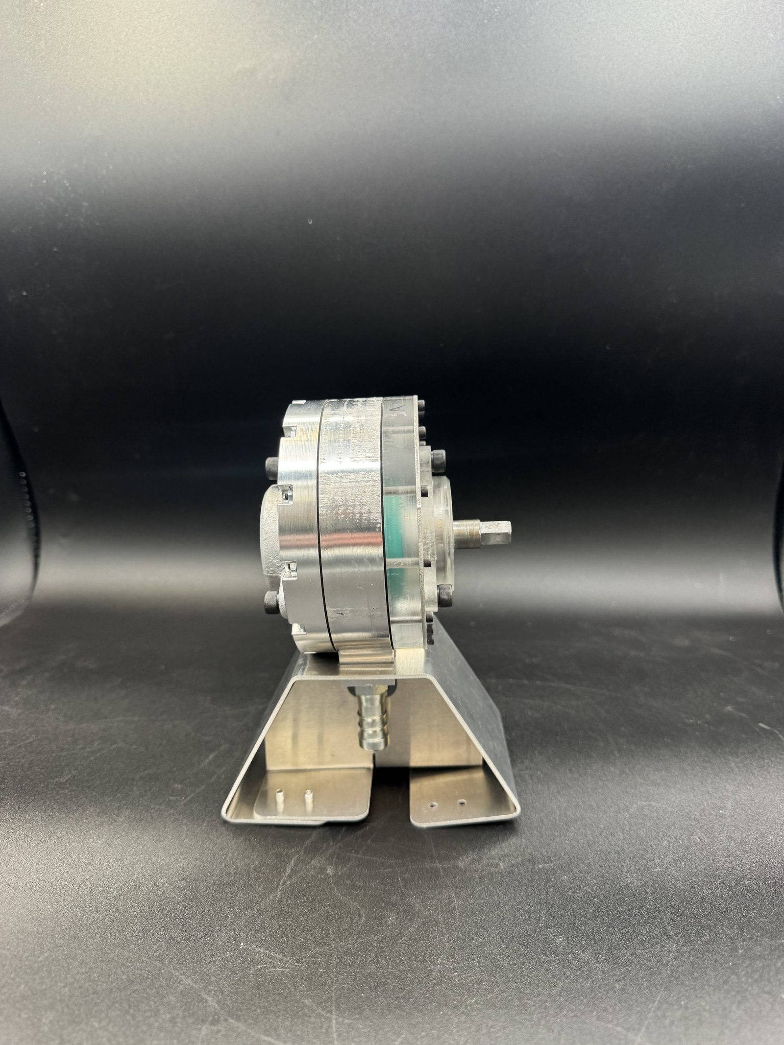Side view of the assembled pump on its mounting bracket showing the output shaft