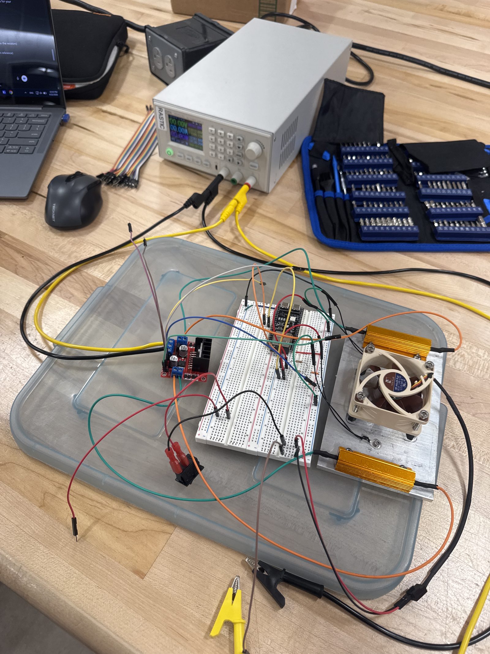 Full test bench with ESP32 on a breadboard, RASTIC-labeled power supply, and wiring to the heater plate